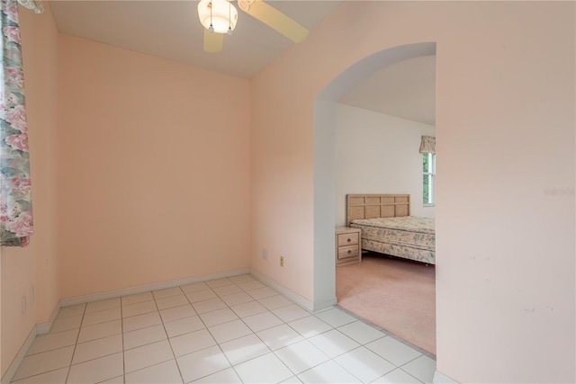 1156 Ridgegrove Dr W, Palm Harbor, FL 34683 - empty room featuring arched walkways and light tile patterned floors