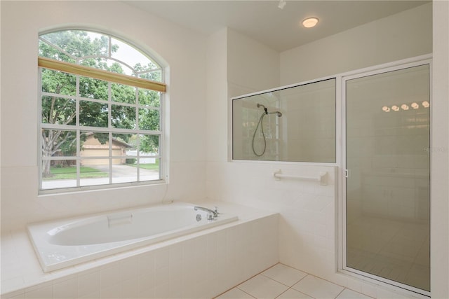 1156 Ridgegrove Dr W, Palm Harbor, FL 34683 - bathroom with a bath, a shower stall, plenty of natural light, and tile patterned floors