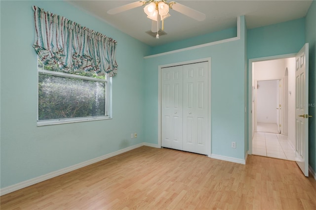 1156 Ridgegrove Dr W, Palm Harbor, FL 34683 - unfurnished bedroom featuring wood finished floors, a closet, and a ceiling fan