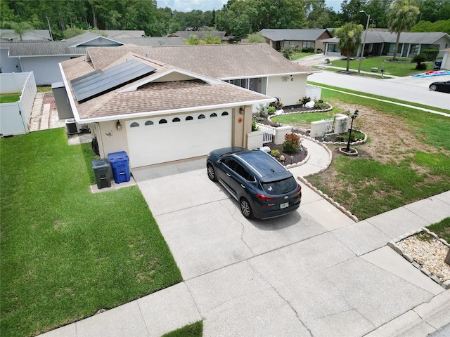8110 Damara Dr, New Port Richey, FL 34653 - view of front facade featuring a shingled roof, driveway, a residential view, solar panels, and a garage