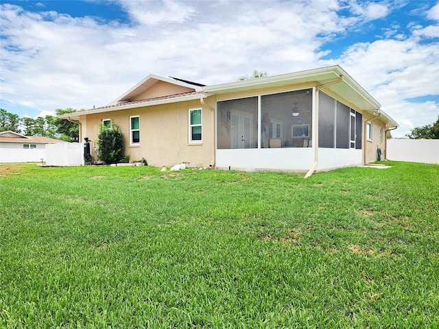 8110 Damara Dr, New Port Richey, FL 34653 - rear view of house featuring a sunroom and stucco siding