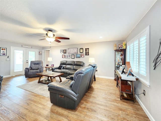 8110 Damara Dr, New Port Richey, FL 34653 - living room with a ceiling fan and light wood-style flooring