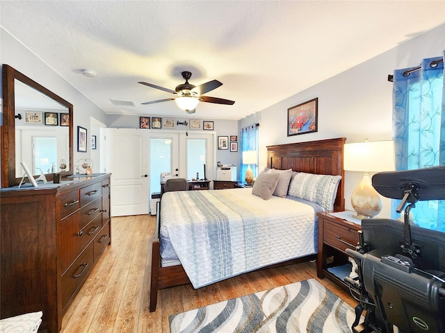8110 Damara Dr, New Port Richey, FL 34653 - bedroom with light wood-style floors and ceiling fan