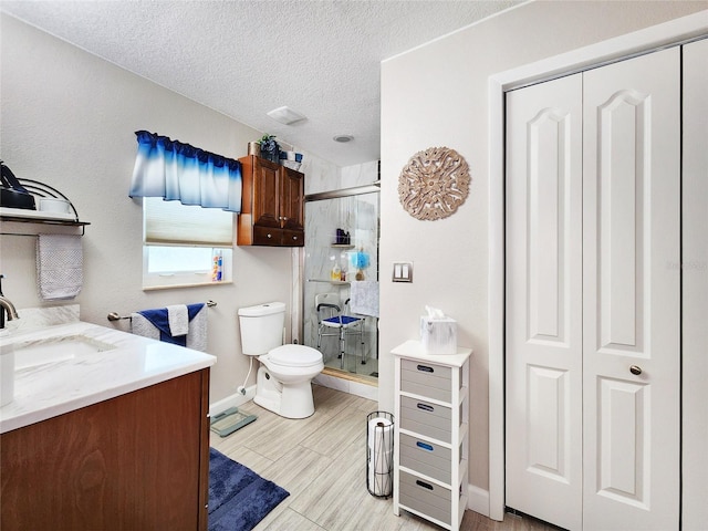 8110 Damara Dr, New Port Richey, FL 34653 - bathroom featuring vanity, a shower stall, a textured ceiling, and a closet