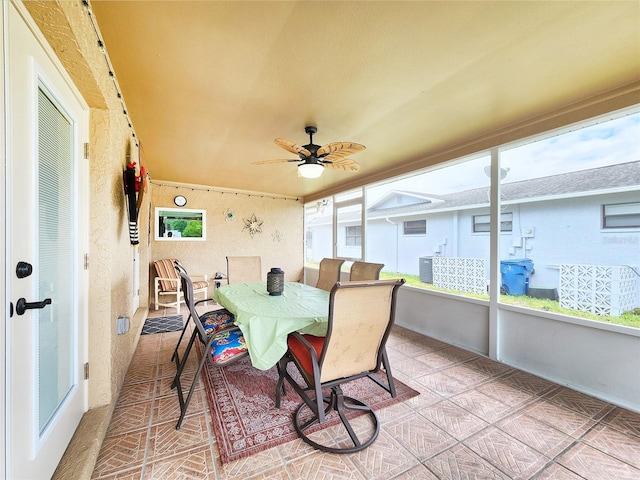 8110 Damara Dr, New Port Richey, FL 34653 - sunroom with ceiling fan and outdoor dining space