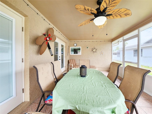 8110 Damara Dr, New Port Richey, FL 34653 - sunroom / solarium featuring a ceiling fan, outdoor dining area, and french doors