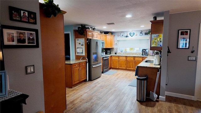 8110 Damara Dr, New Port Richey, FL 34653 - kitchen with light wood-style flooring, light stone counters, appliances with stainless steel finishes, open shelves, and recessed lighting