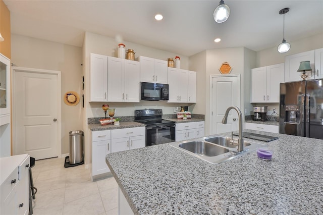 4485 Eternal Prince Dr, Sun City Center, FL 33573 - kitchen with black appliances, white cabinets, decorative light fixtures, light tile patterned floors, and recessed lighting
