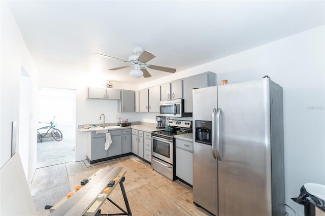 120371/2 Murray Ave, Seminole, FL 33778 - kitchen featuring appliances with stainless steel finishes, gray cabinets, light countertops, ceiling fan, and light wood-type flooring