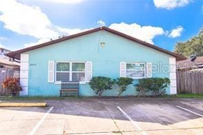 1021 16th Ave SW, Largo, FL 33770 - view of side of property featuring uncovered parking and stucco siding