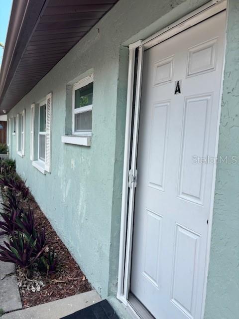 1021 16th Ave SW, Largo, FL 33770 - property entrance featuring stucco siding