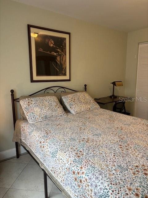 1021 16th Ave SW, Largo, FL 33770 - bedroom featuring light tile patterned flooring and a closet