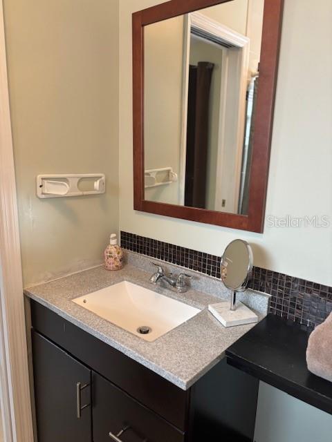 1021 16th Ave SW, Largo, FL 33770 - bathroom featuring vanity and tasteful backsplash