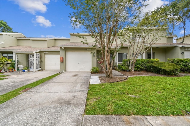 1508 Adams Cir E, Largo, FL 33771 - view of property featuring driveway, stucco siding, a front yard, and an attached garage