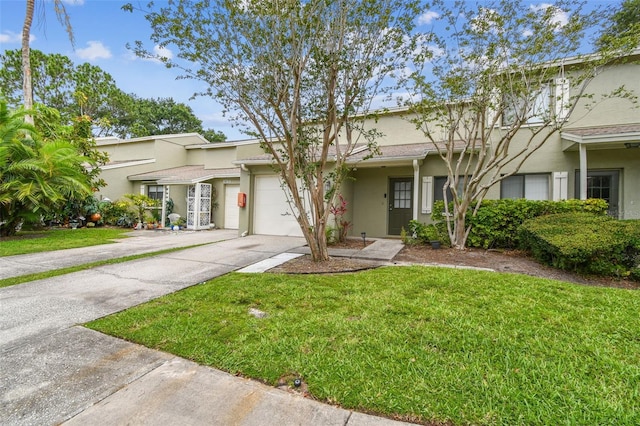 1508 Adams Cir E, Largo, FL 33771 - view of front of house with driveway, stucco siding, an attached garage, and a front lawn
