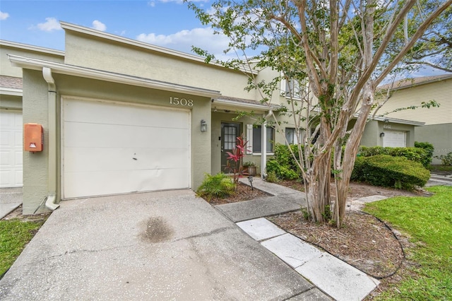 1508 Adams Cir E, Largo, FL 33771 - townhome / multi-family property with driveway, stucco siding, and a garage