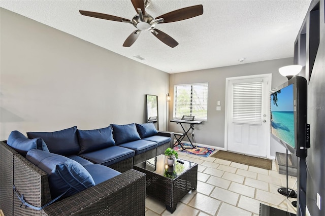 1508 Adams Cir E, Largo, FL 33771 - living room with a ceiling fan, a textured ceiling, and light tile patterned flooring