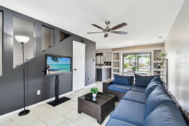 1508 Adams Cir E, Largo, FL 33771 - living area featuring ceiling fan, light tile patterned floors, and a textured ceiling