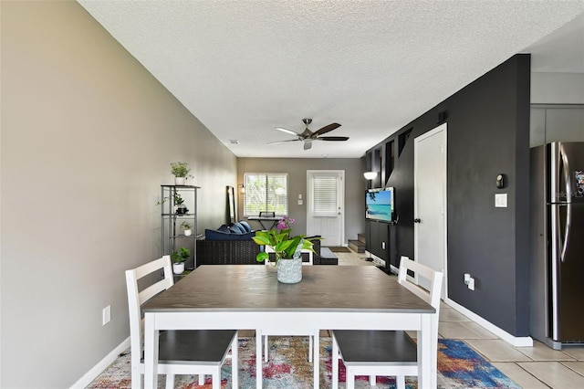 1508 Adams Cir E, Largo, FL 33771 - dining area featuring a ceiling fan, light tile patterned floors, and a textured ceiling