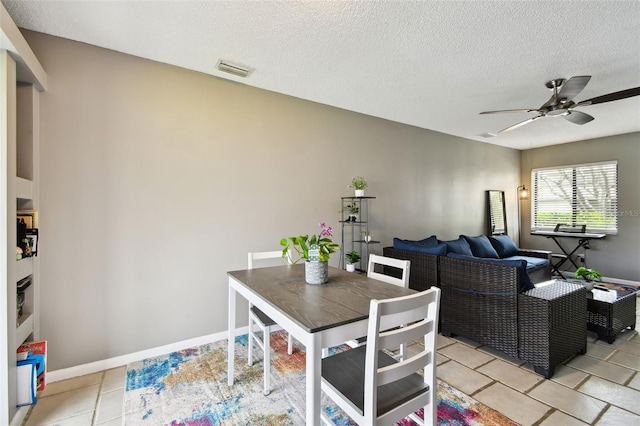 1508 Adams Cir E, Largo, FL 33771 - dining room with a ceiling fan, a textured ceiling, and light tile patterned floors
