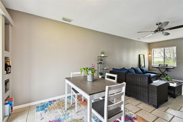 1508 Adams Cir E, Largo, FL 33771 - dining room with a ceiling fan, a textured ceiling, and light tile patterned floors