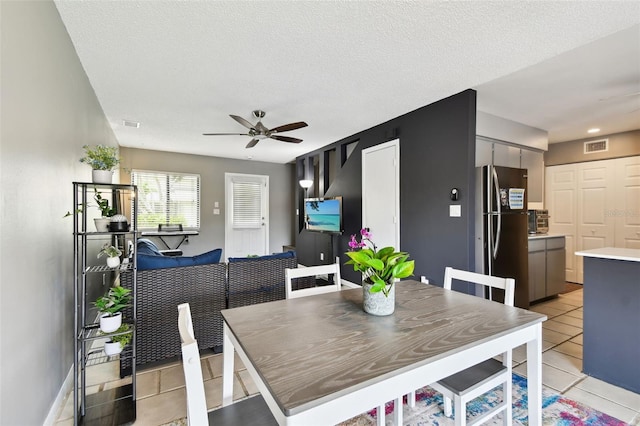 1508 Adams Cir E, Largo, FL 33771 - dining space featuring a ceiling fan, light tile patterned floors, and a textured ceiling