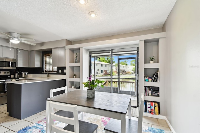 1508 Adams Cir E, Largo, FL 33771 - dining space with a textured ceiling, healthy amount of natural light, a ceiling fan, light tile patterned floors, and built in features