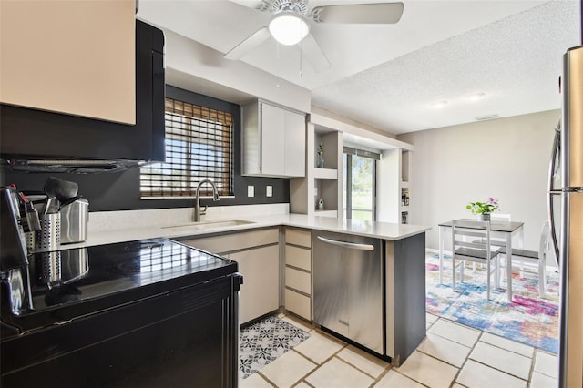 1508 Adams Cir E, Largo, FL 33771 - kitchen with appliances with stainless steel finishes, a peninsula, light countertops, ceiling fan, and light tile patterned flooring