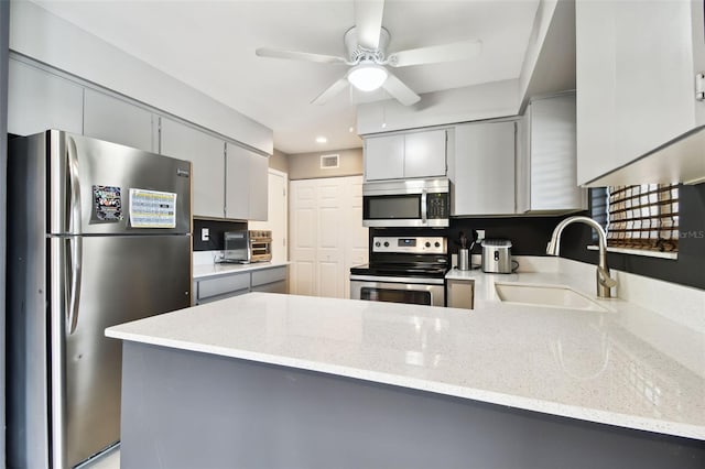 1508 Adams Cir E, Largo, FL 33771 - kitchen with stainless steel appliances, gray cabinetry, a peninsula, and ceiling fan