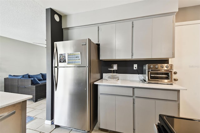 1508 Adams Cir E, Largo, FL 33771 - kitchen with appliances with stainless steel finishes, light countertops, light tile patterned flooring, and gray cabinetry