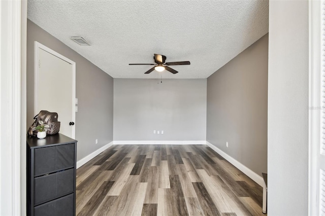 1508 Adams Cir E, Largo, FL 33771 - spare room with a ceiling fan, dark wood-style flooring, and a textured ceiling