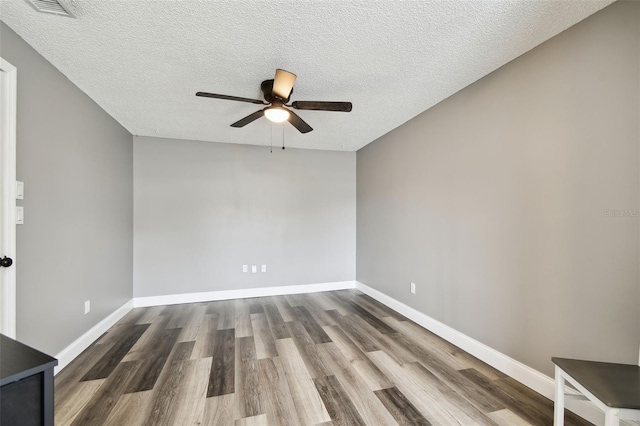 1508 Adams Cir E, Largo, FL 33771 - empty room featuring wood finished floors, ceiling fan, and a textured ceiling