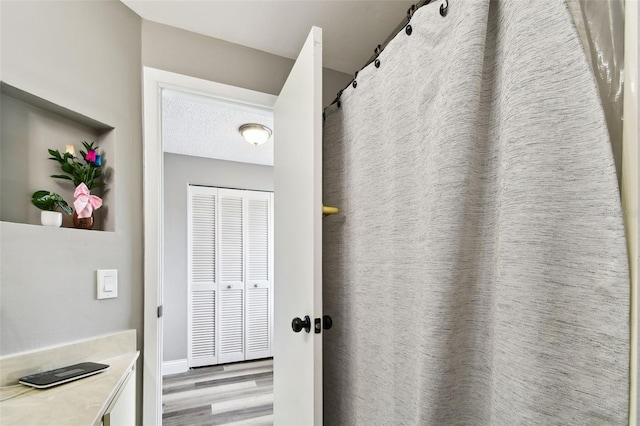 1508 Adams Cir E, Largo, FL 33771 - full bathroom featuring wood finished floors, vanity, and a shower with curtain