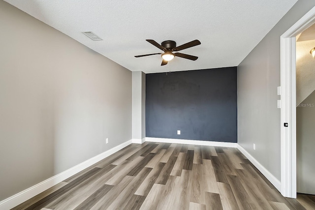 1508 Adams Cir E, Largo, FL 33771 - empty room featuring ceiling fan, wood finished floors, and a textured ceiling