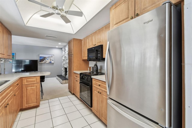 2418 Cardwell Way, Sarasota, FL 34231 - kitchen featuring black appliances, a ceiling fan, light carpet, and light countertops