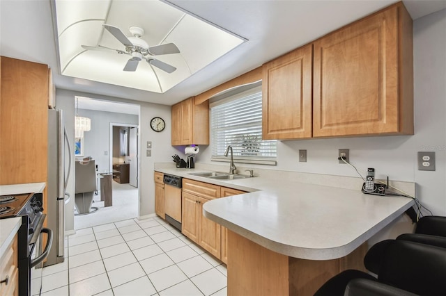 2418 Cardwell Way, Sarasota, FL 34231 - kitchen featuring appliances with stainless steel finishes, ceiling fan, light countertops, a kitchen breakfast bar, and a peninsula