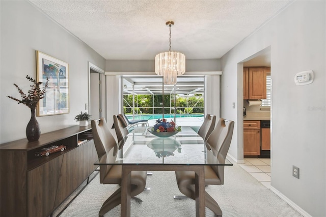 2418 Cardwell Way, Sarasota, FL 34231 - dining area featuring a textured ceiling, light carpet, and a chandelier