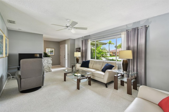 2418 Cardwell Way, Sarasota, FL 34231 - living area with a textured ceiling, ceiling fan, healthy amount of natural light, and carpet flooring