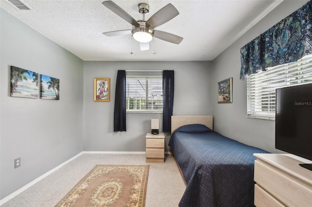 2418 Cardwell Way, Sarasota, FL 34231 - bedroom featuring light colored carpet, a textured ceiling, and a ceiling fan
