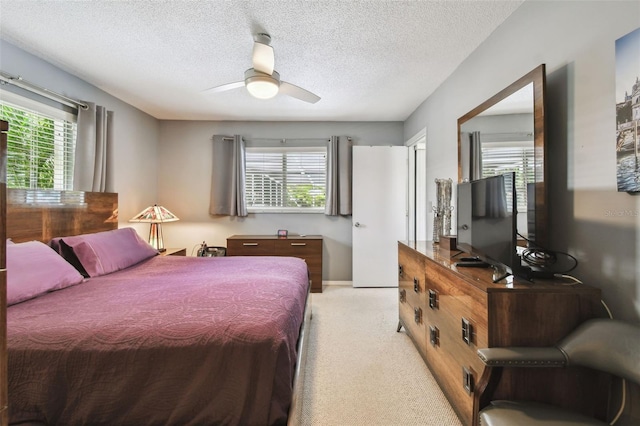 2418 Cardwell Way, Sarasota, FL 34231 - bedroom with light colored carpet, multiple windows, a textured ceiling, and ceiling fan