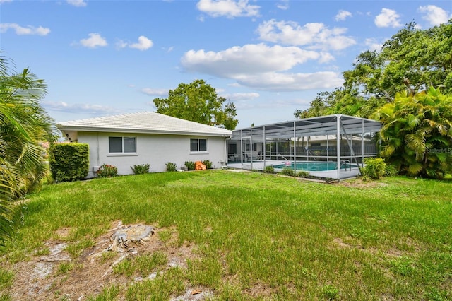 2418 Cardwell Way, Sarasota, FL 34231 - rear view of house featuring stucco siding, a lawn, and a lanai