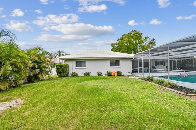 2418 Cardwell Way, Sarasota, FL 34231 - rear view of house with stucco siding, an outdoor pool, a lawn, a lanai, and a tile roof