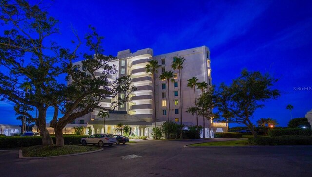 2 Seaside Ln Unit 203, Belleair, FL 33756 - property at night featuring uncovered parking
