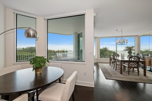 2 Seaside Ln Unit 203, Belleair, FL 33756 - dining space with dark wood-style floors and a chandelier