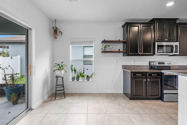 1821 Hawks View Dr, Ruskin, FL 33570 - kitchen with appliances with stainless steel finishes, open shelves, dark stone countertops, light tile patterned flooring, and recessed lighting