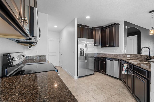 1821 Hawks View Dr, Ruskin, FL 33570 - kitchen with stainless steel appliances, dark stone counters, arched walkways, pendant lighting, and recessed lighting