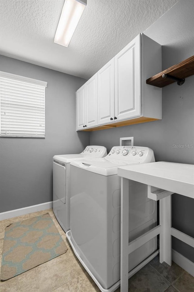 1821 Hawks View Dr, Ruskin, FL 33570 - washroom featuring cabinet space, washing machine and clothes dryer, a textured ceiling, and tile patterned floors