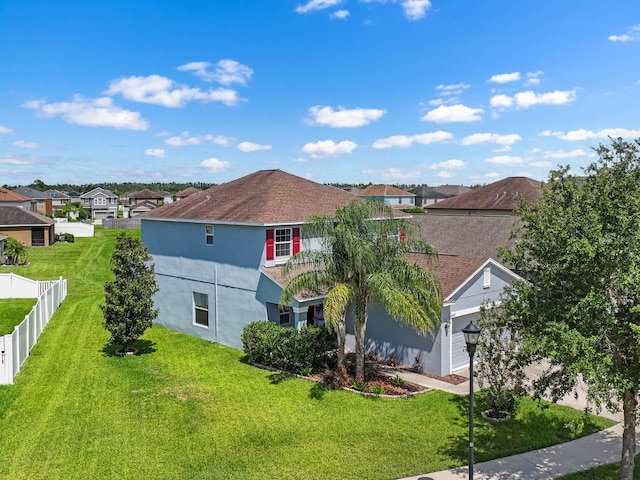 1821 Hawks View Dr, Ruskin, FL 33570 - view of side of home featuring an attached garage, a residential view, and stucco siding