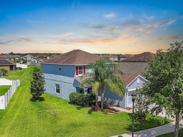 1821 Hawks View Dr, Ruskin, FL 33570 - view of side of property featuring an attached garage, stucco siding, and a residential view