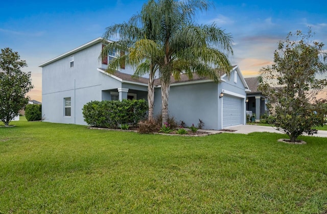 1821 Hawks View Dr, Ruskin, FL 33570 - view of front facade with stucco siding, an attached garage, concrete driveway, and a front lawn